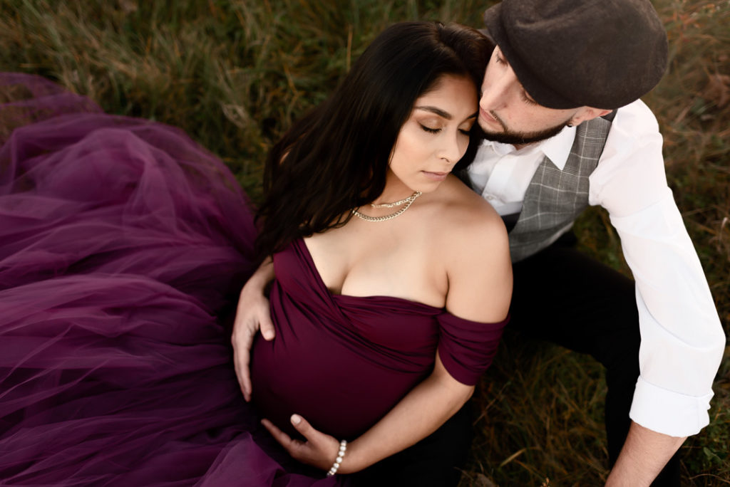 Maternity Photography Couple laying on ground holding belly