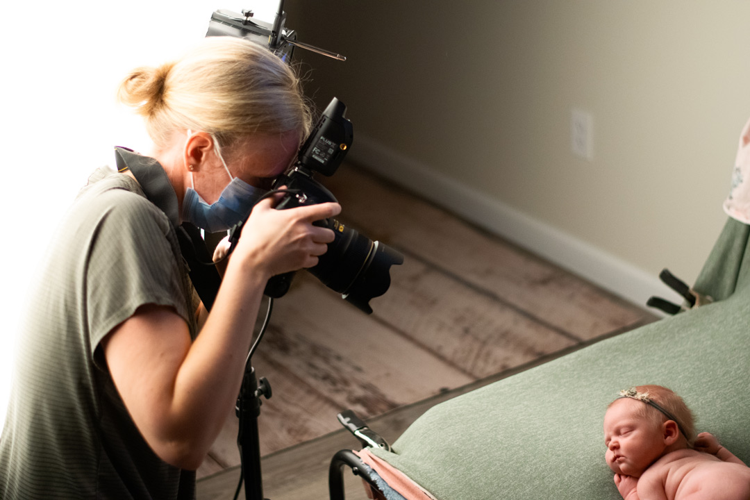 Amanda Armour behind the scenes taking a picture of a baby during a Grand Rapids Newborn Photography session