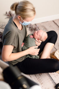 Amanda Armour behind the scenes calming a baby during a Grand Rapids Newborn Photography session