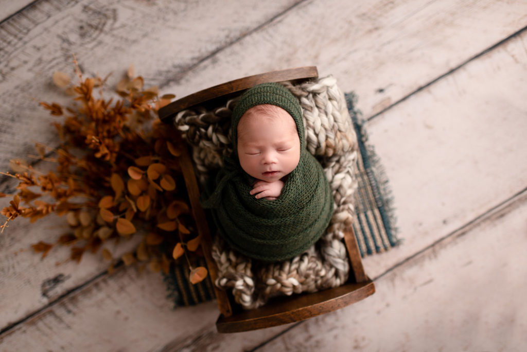 Lansing Newborn Photographer For The Love Of Photography Picture of Newborn Boy with Bonet Wrapped and Posed