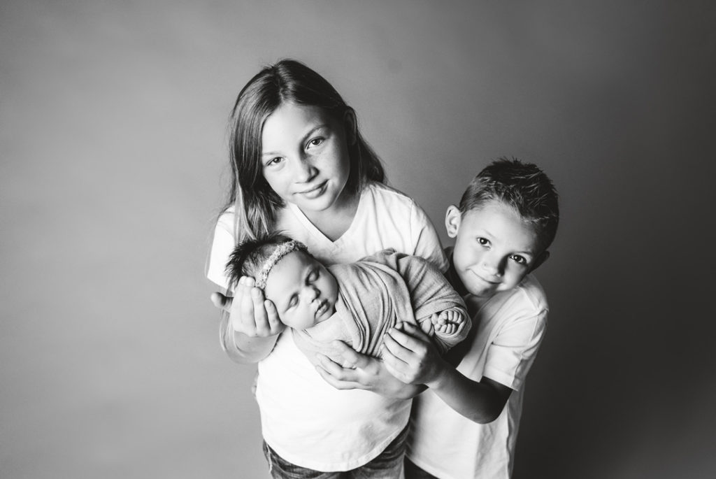 Lansing Newborn Photography Session by For the Love of Photography of Siblings Black And White