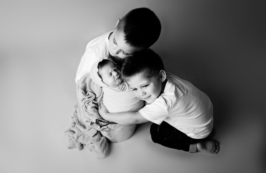 Lansing Newborn Photography Session by For the Love of Photography of Siblings Snuggling Black and White