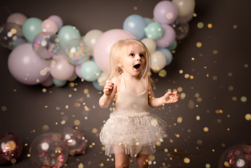 Little Girl with Balloons and Glitter by For The Love Of Photography