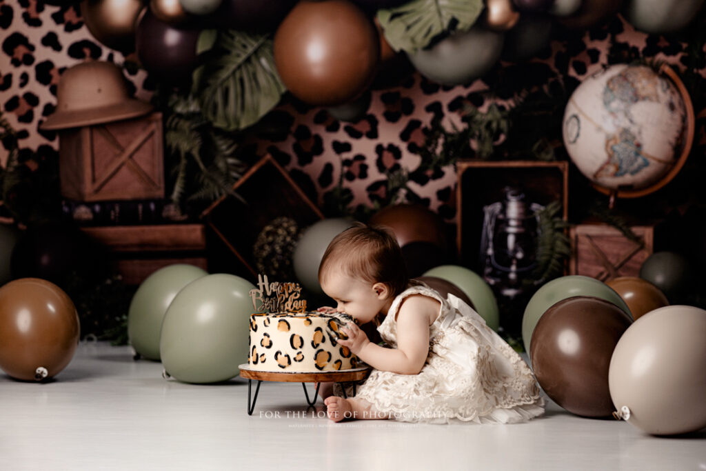Lansing Cake Smash Photographer Toddler Biting Cake by For The Love of Photography